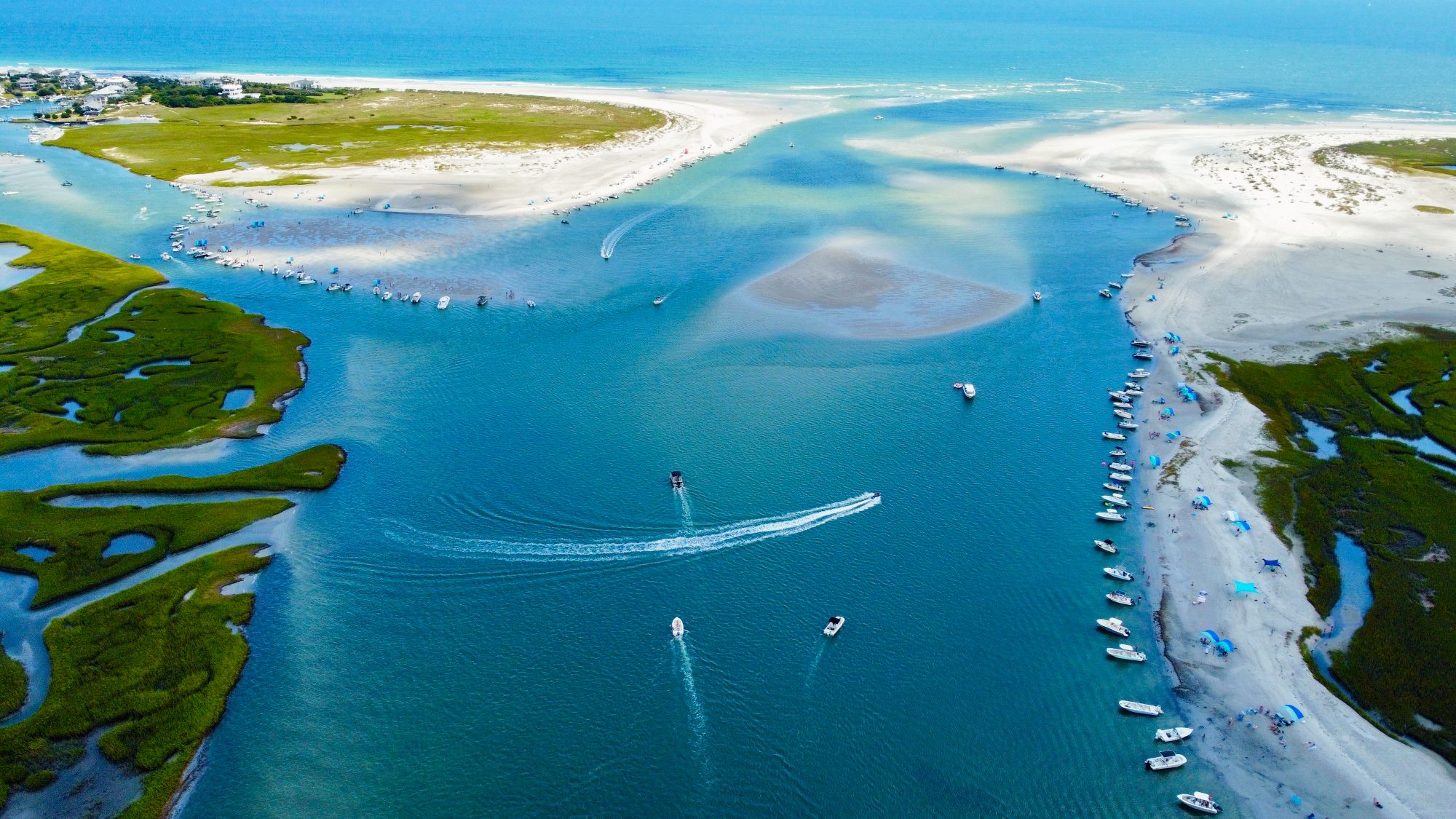 Boats rafted up on the sandbars at Masonboro Inlet