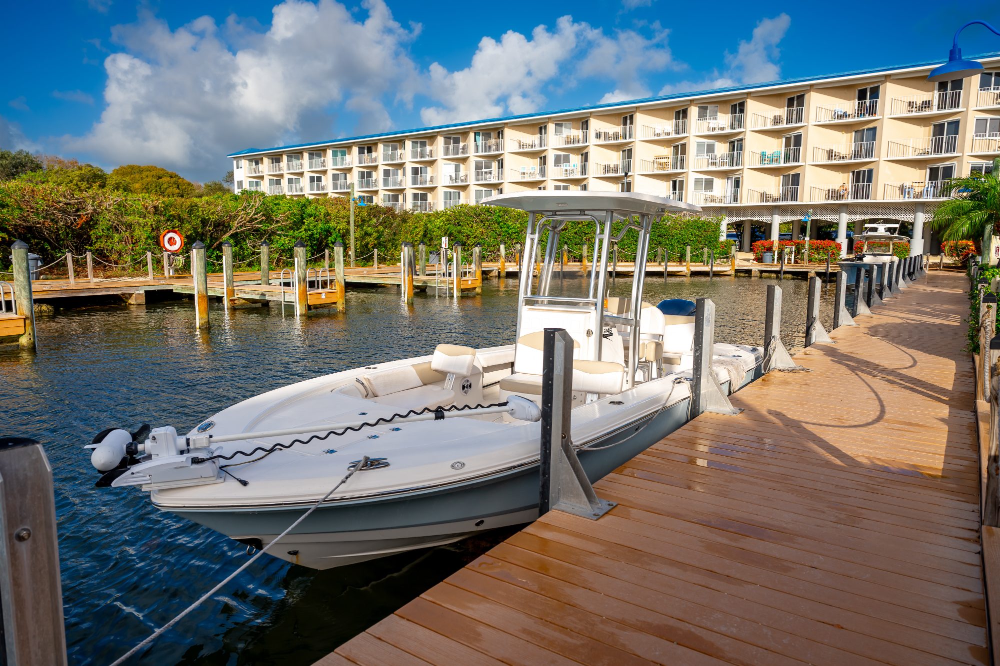 Center-console boat tied up at a marina dock